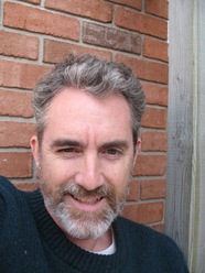man in front of brick wall