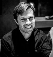 black and white photo of smiling man