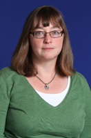 woman in green shirt against blue background