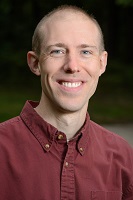 man in red shirt with short hair